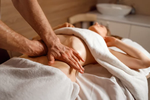 masseur-s-hands-massaging-the-patient-s-abdomen-2023-01-26-03-51-36-utc